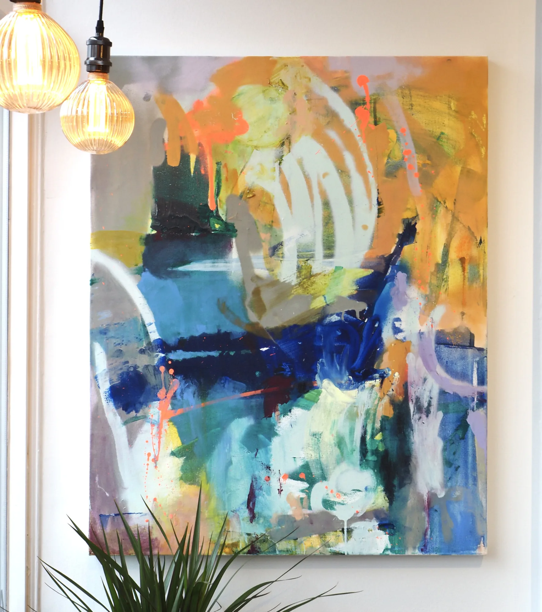 An abstract hung beside the pendant lights