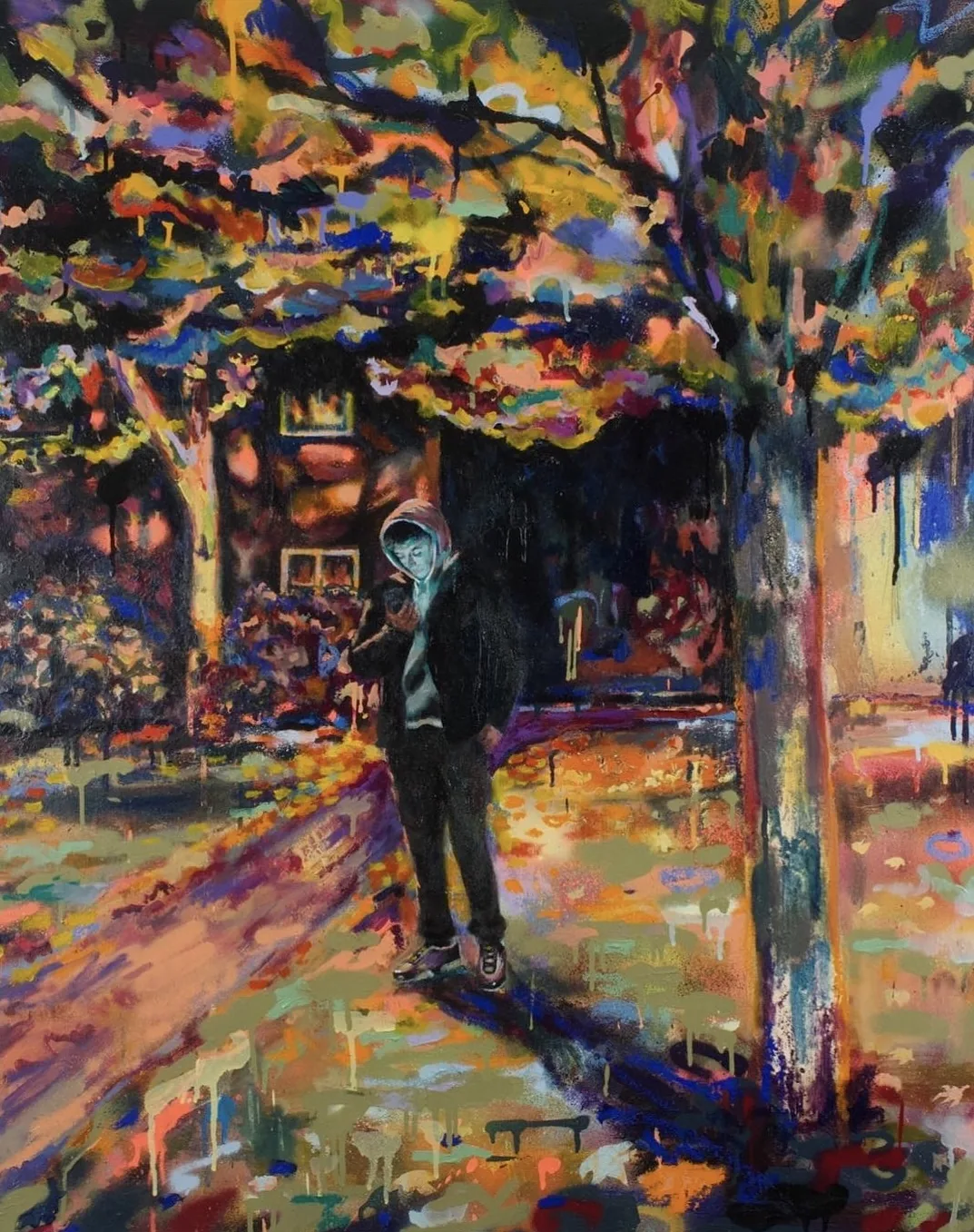 A hooded figure standing on a path under autumn trees